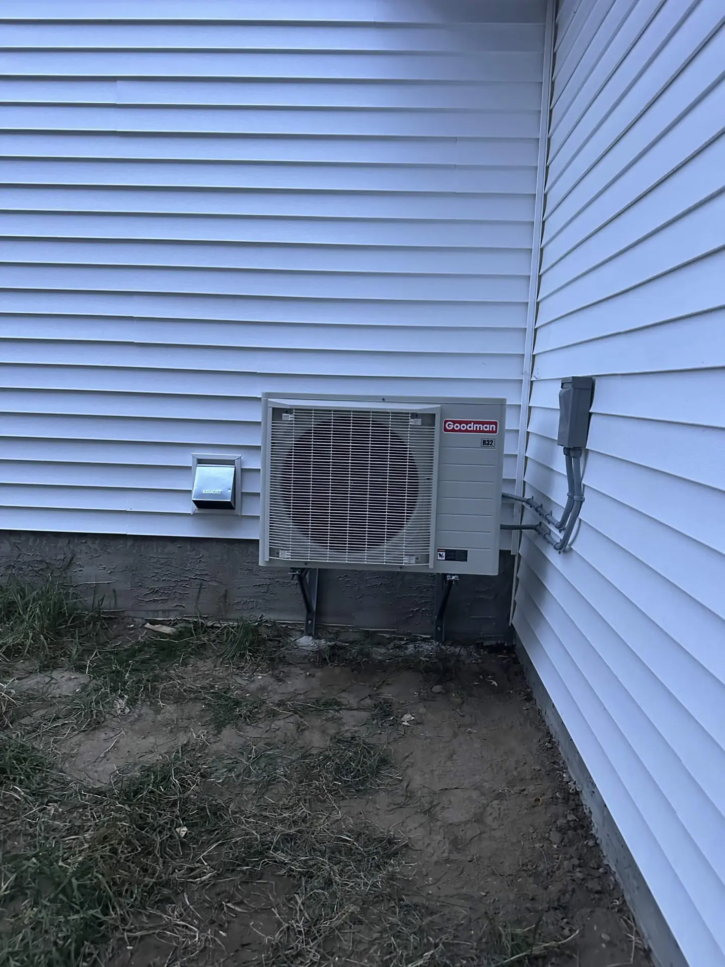 Goodman central air conditioner installed beside a home
