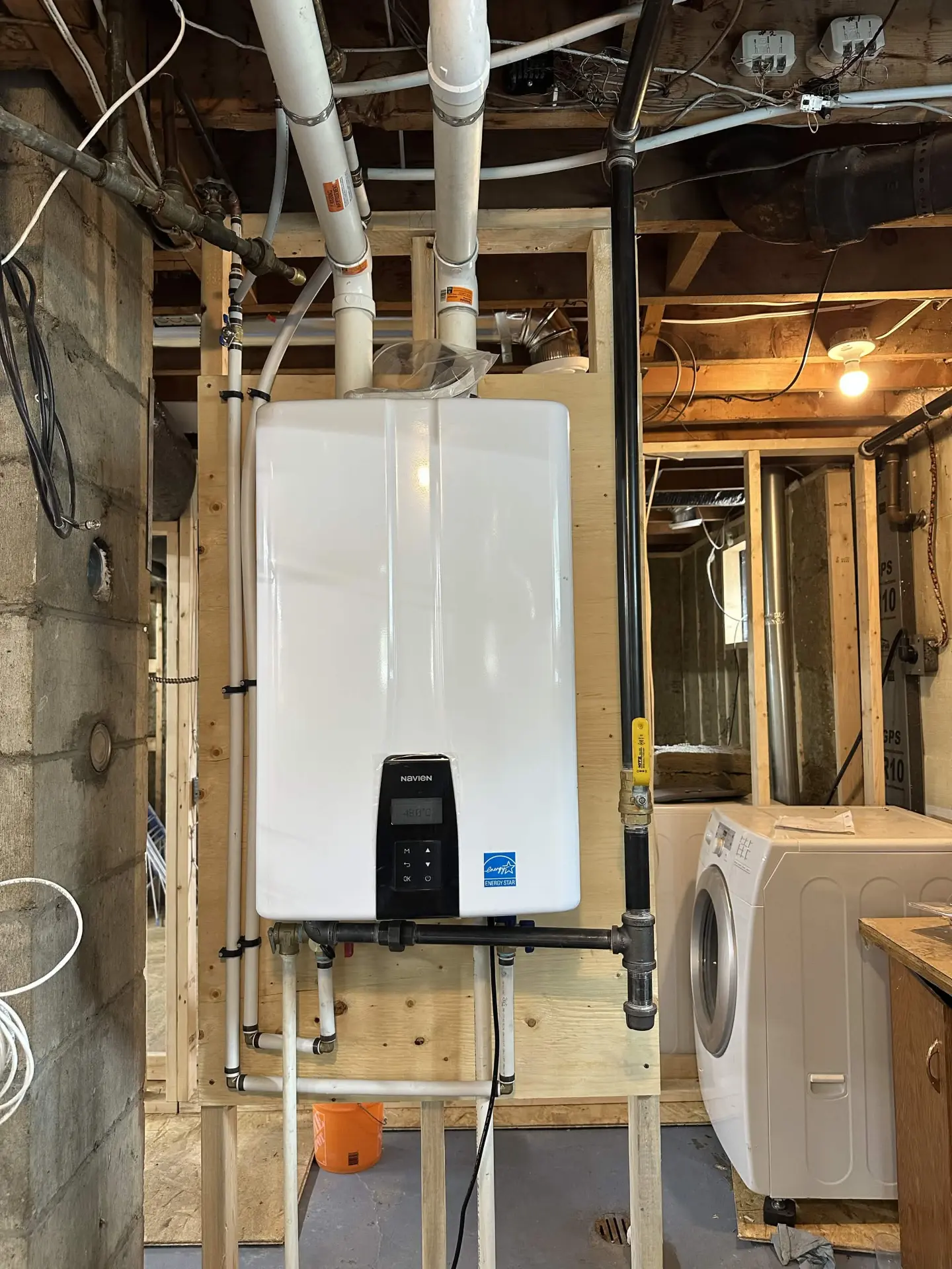 Navien tankless water heater installed in a basement utility area