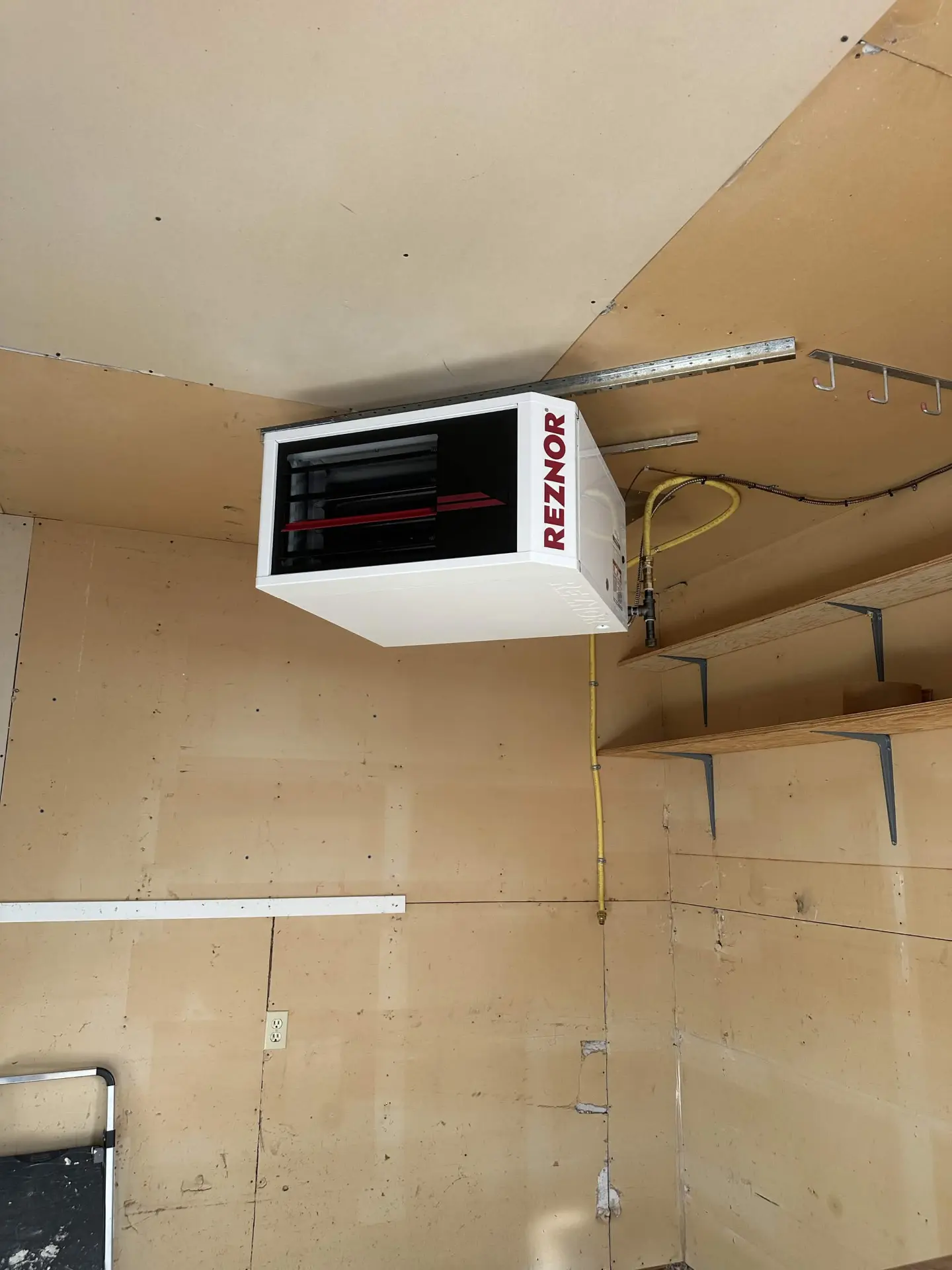 Reznor unit heater suspended in an unfinished garage