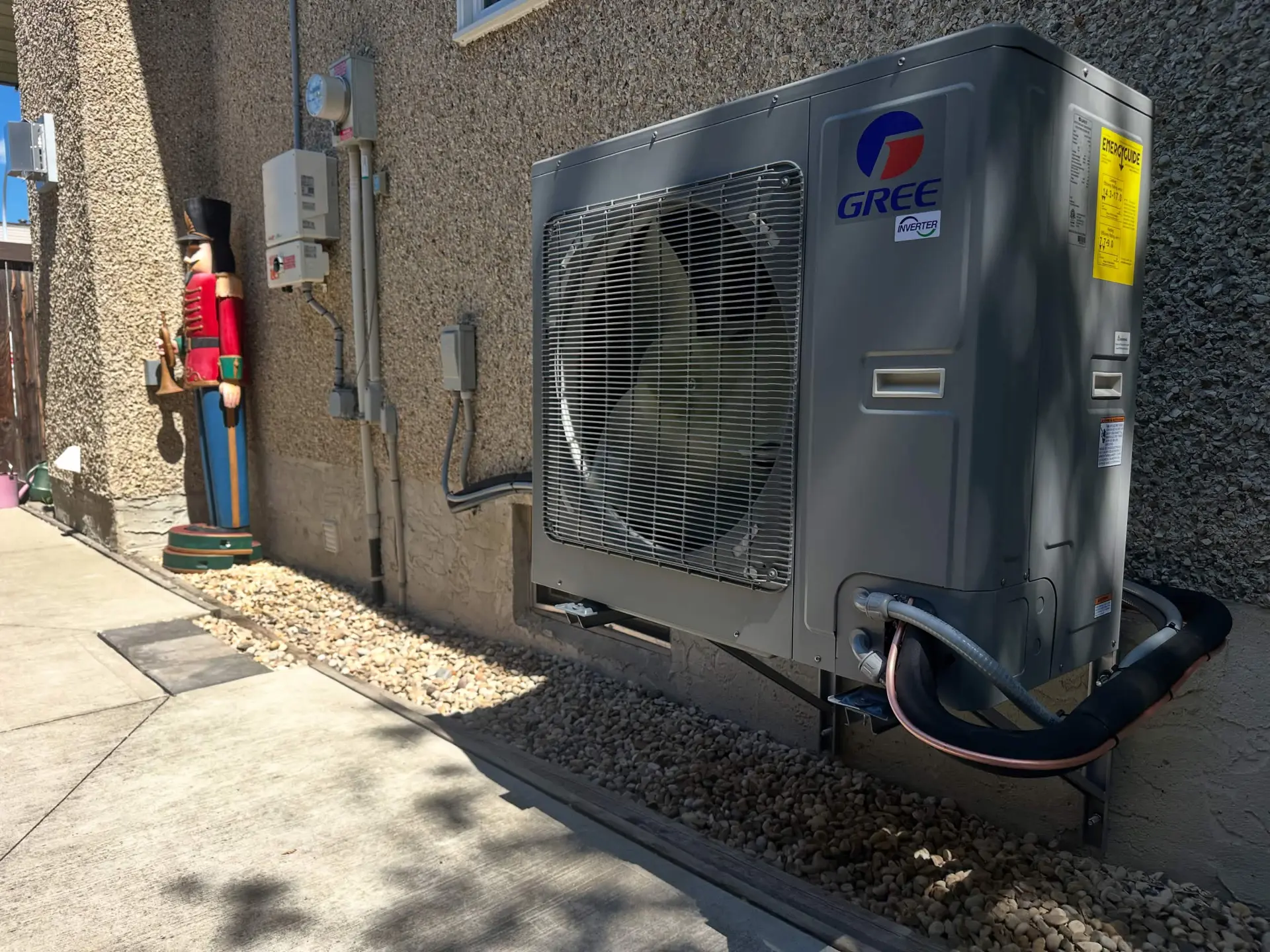 Gree inverter heat pump installed beside a residential home